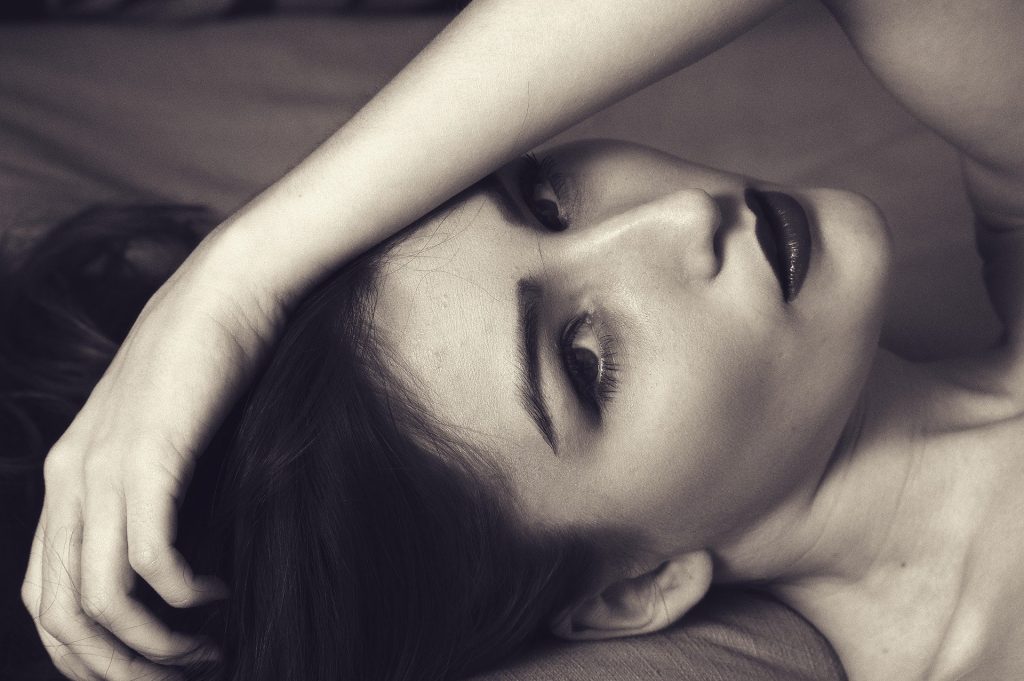 A close up of a person lying down and looking at the camera