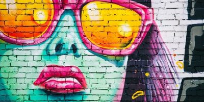 A person with graffiti on the side of a building